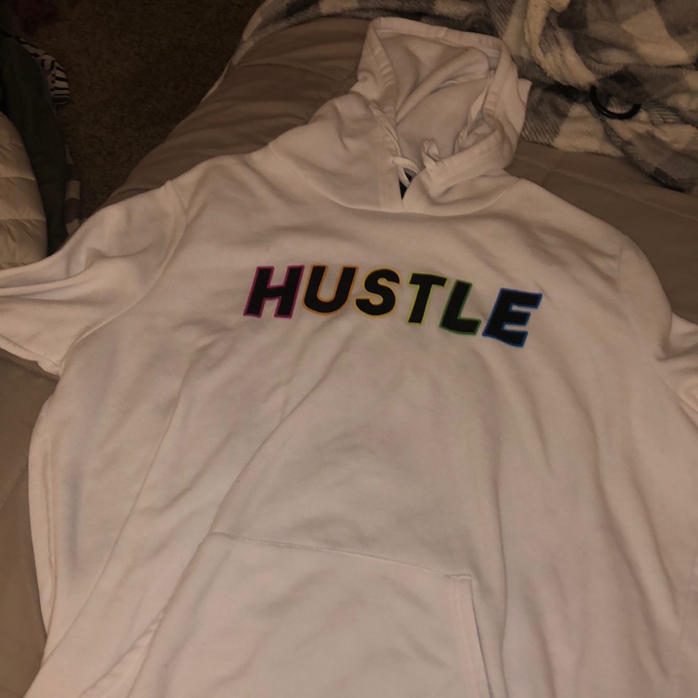 rainbow lettering on white sweatshirt “HUSTLE”